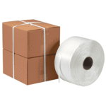 Cardboard boxes strapped with plastic packing belt by automatic strapping machine